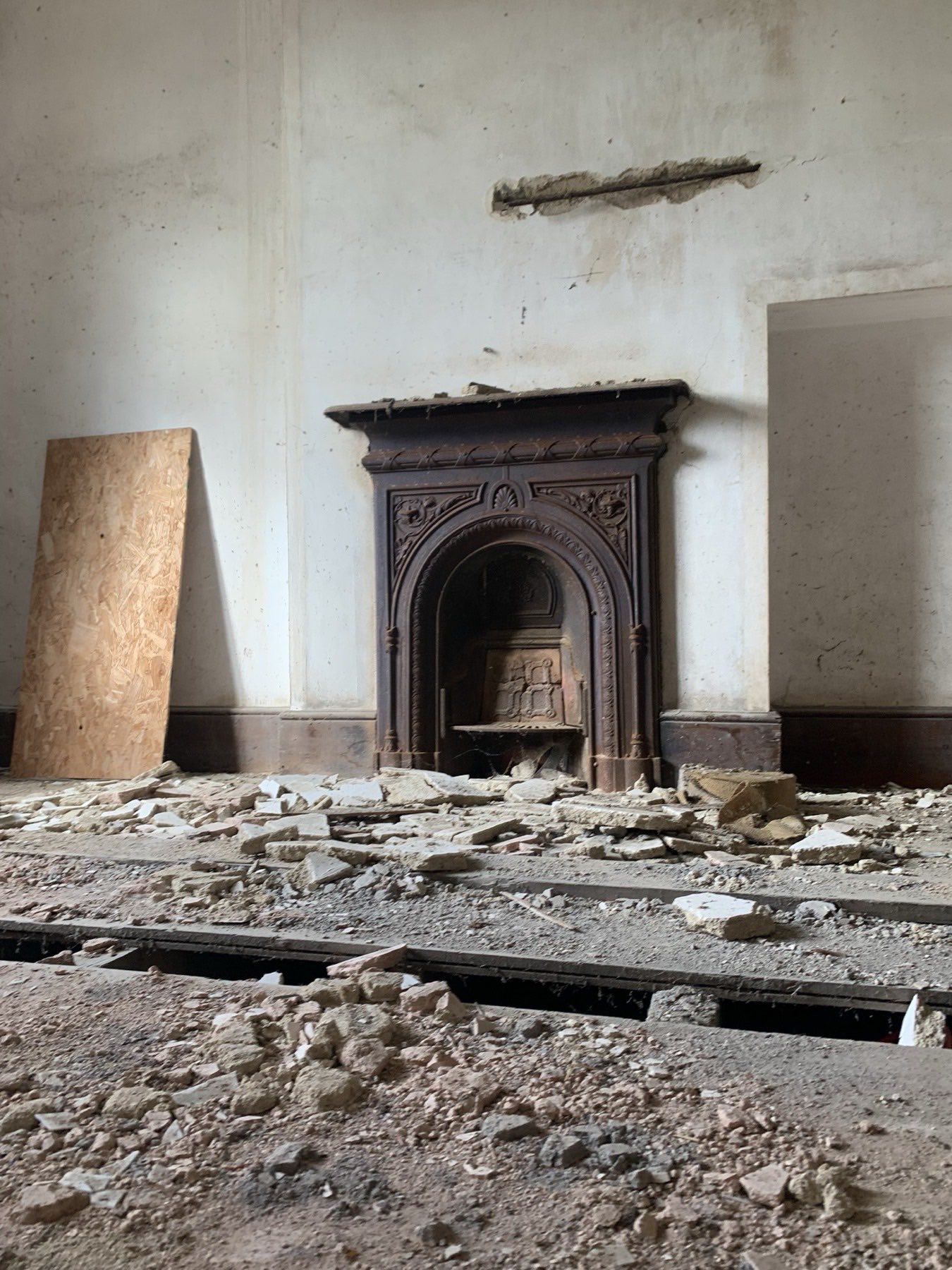 Victorian cast-iron fireplace in a listed interior awaiting restoration